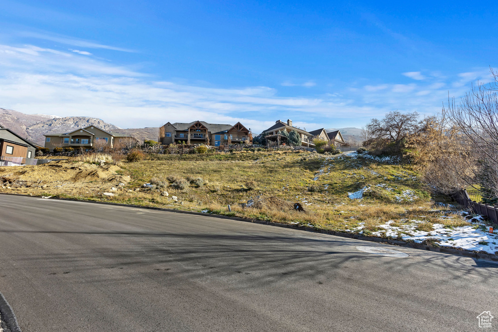 View of front of home with a mountain view and a residential view