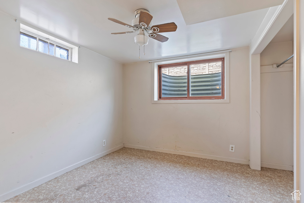 Unfurnished bedroom featuring baseboards, light carpet, and ceiling fan