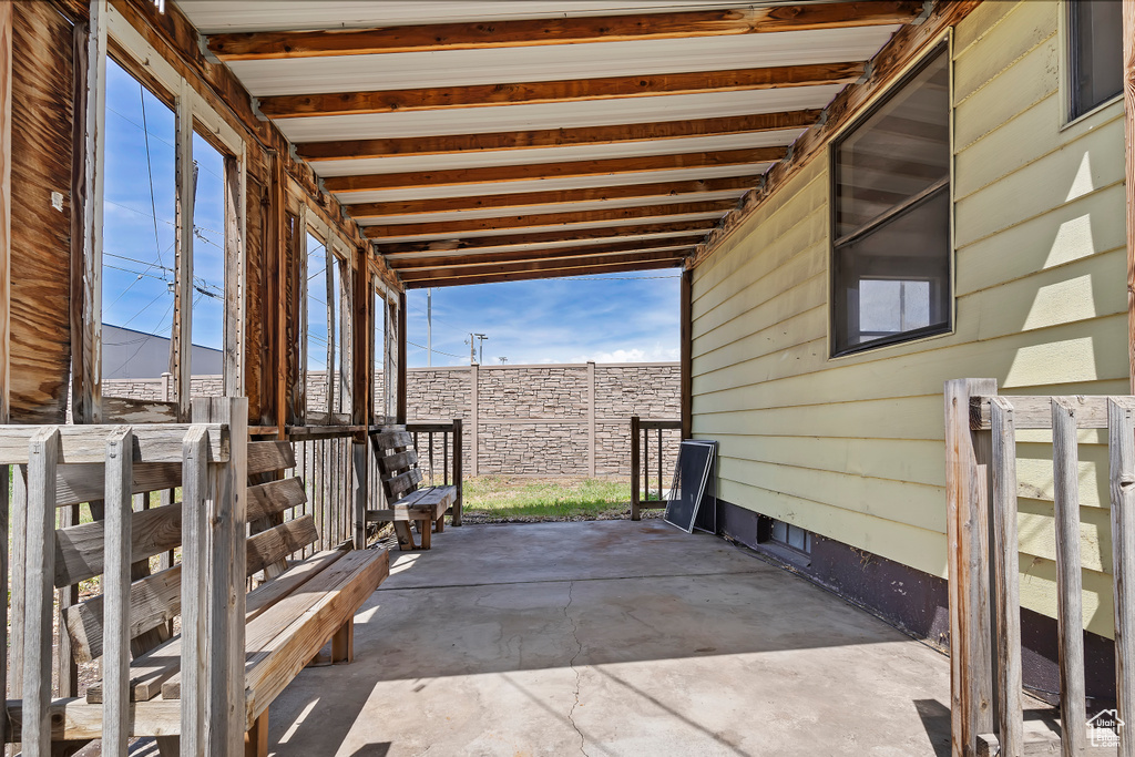 View of patio featuring fence
