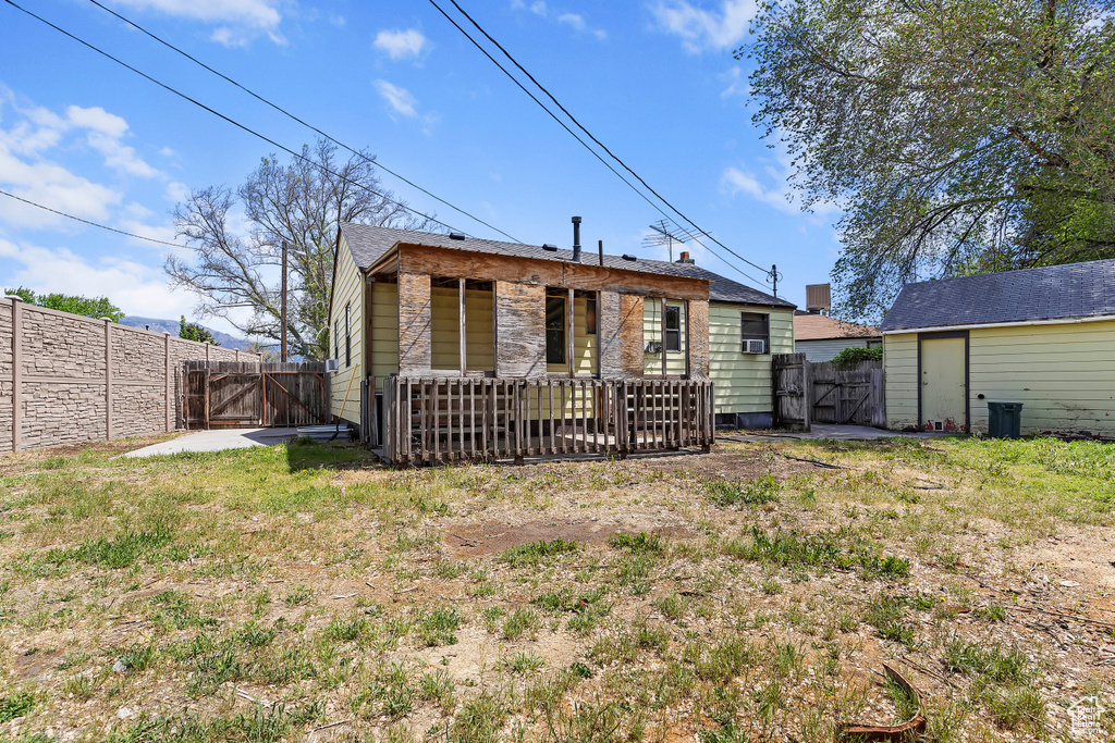 Rear view of house featuring a gate and a fenced backyard