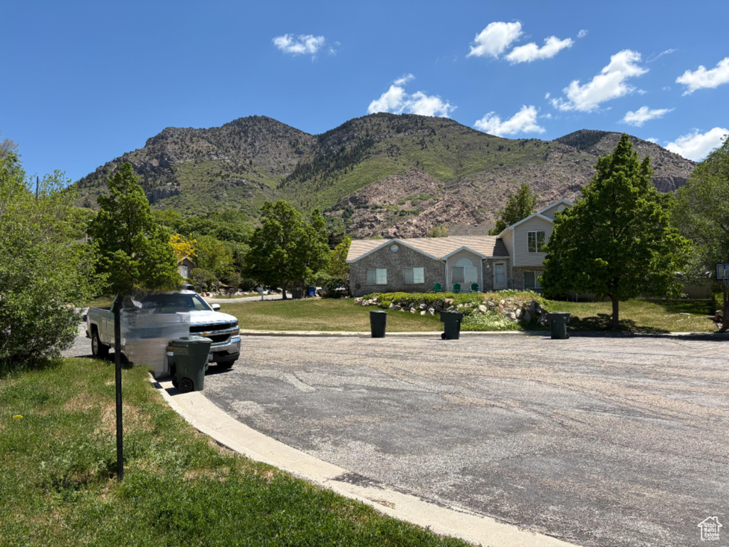 View of asphalt street with a mountain view and curbs