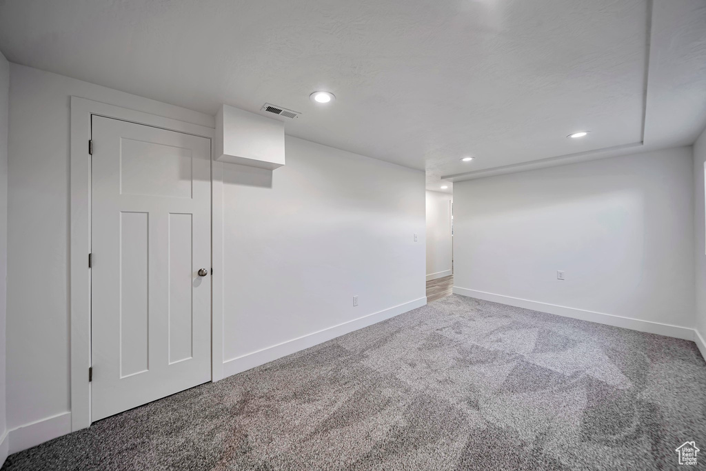Finished below grade area with carpet, baseboards, and recessed lighting