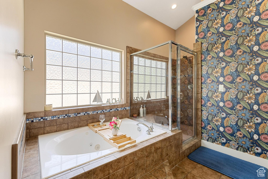 Full bathroom featuring a stall shower, a tub with jets, and tile patterned floors