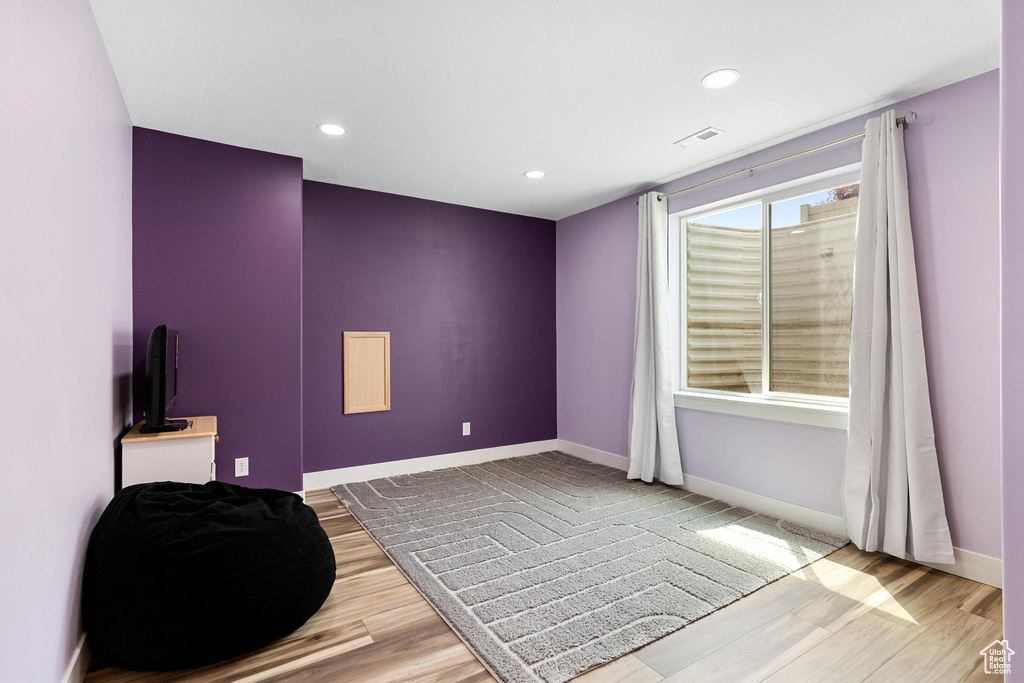 Unfurnished bedroom with wood finished floors, baseboards, and recessed lighting