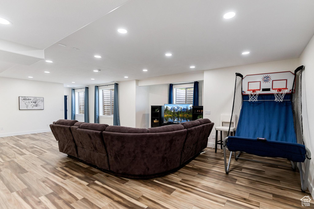Living area featuring light wood-type flooring, baseboards, and recessed lighting