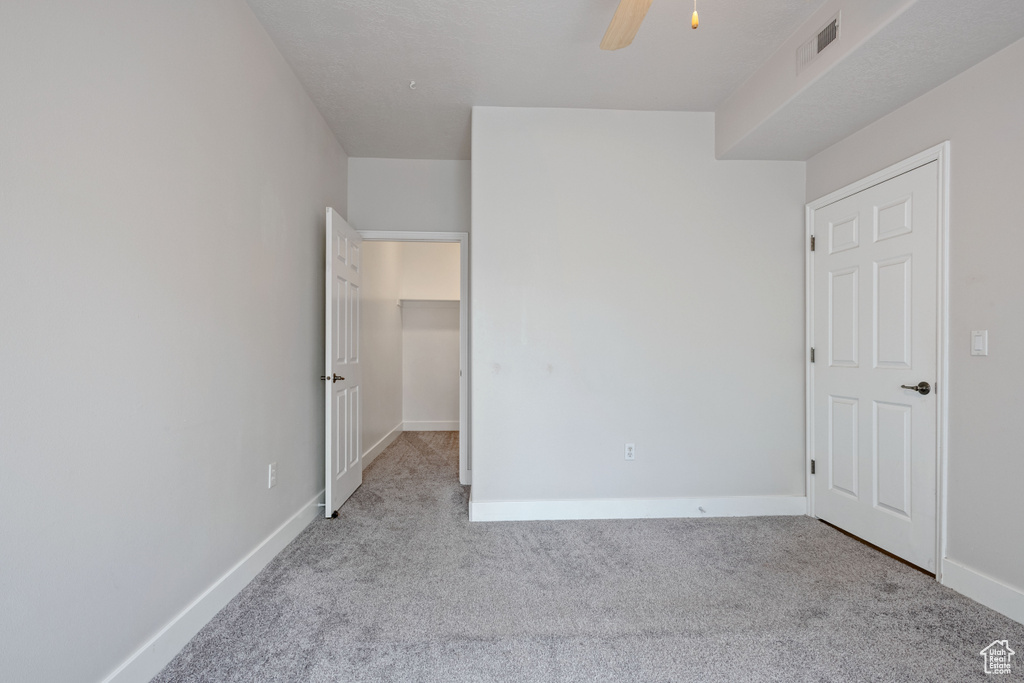 Unfurnished bedroom with carpet flooring, baseboards, and ceiling fan