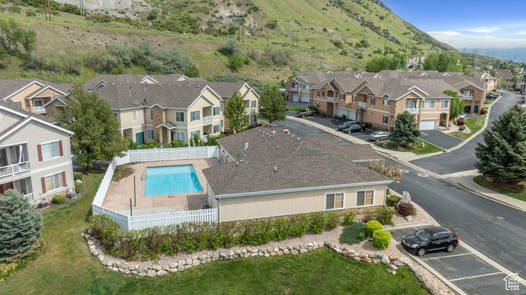 Aerial view of residential area with a mountainous background and a pool area