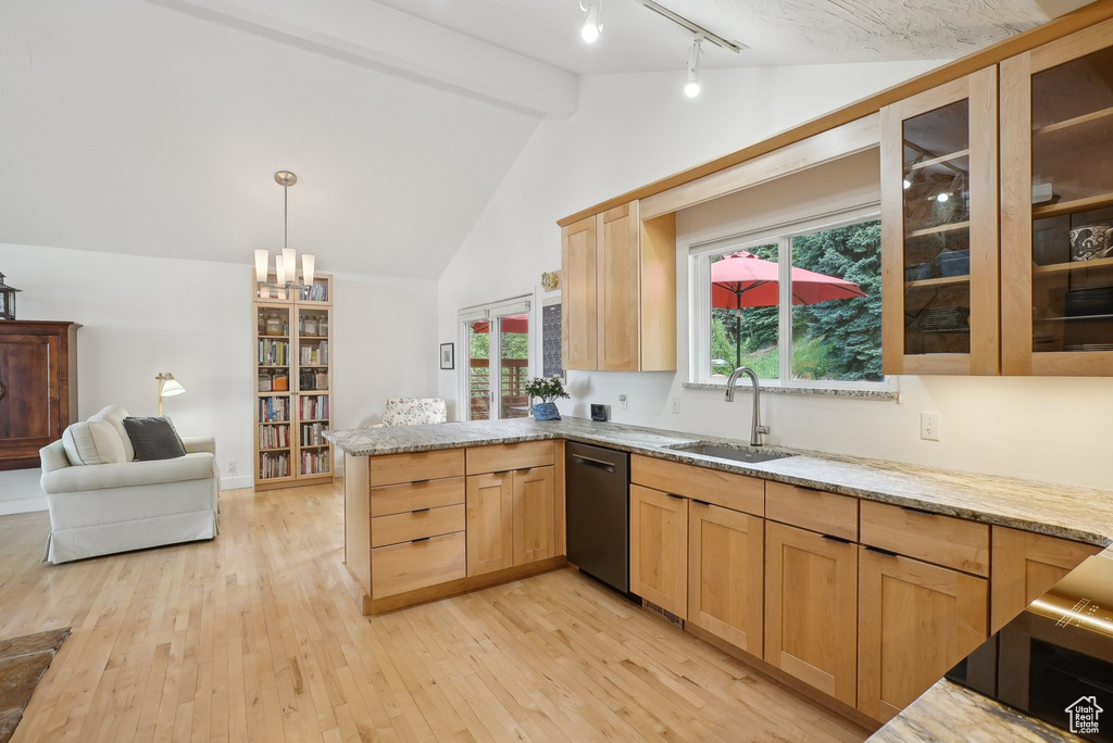 Kitchen featuring a sink, stainless steel dishwasher, a peninsula, light brown cabinets, and light wood-type flooring