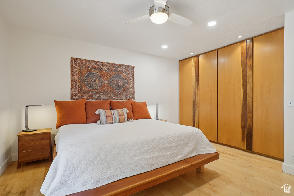 Bedroom with light wood finished floors, recessed lighting, baseboards, and a ceiling fan