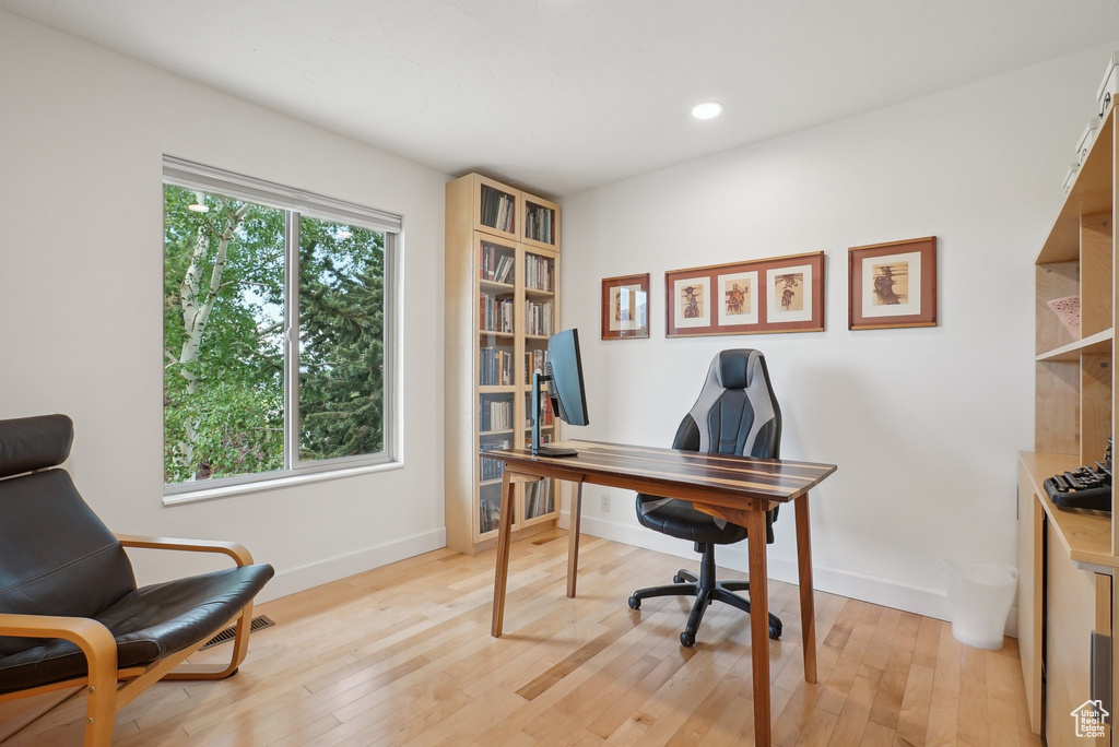 Home office featuring baseboards, light wood-style floors, and recessed lighting