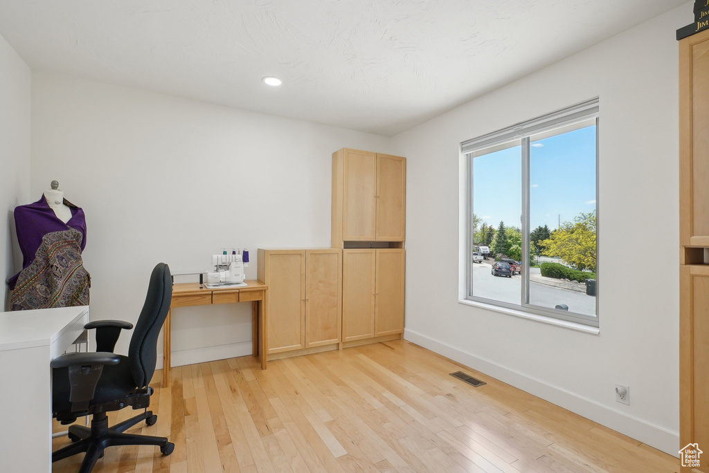 Home office with light wood finished floors, baseboards, and recessed lighting