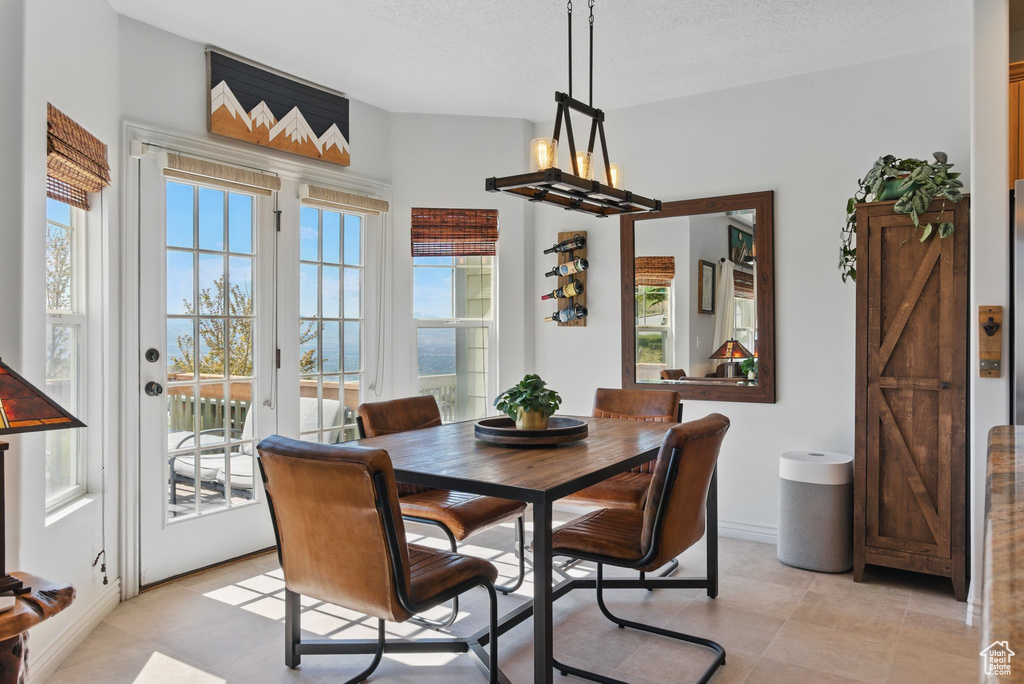 Dining room featuring plenty of natural light, baseboards, and light tile patterned flooring