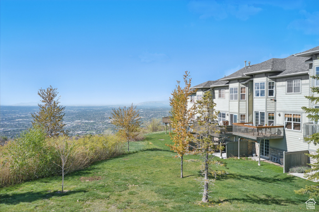 View of green lawn featuring a deck