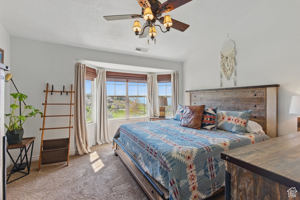 Carpeted bedroom with ceiling fan and baseboards