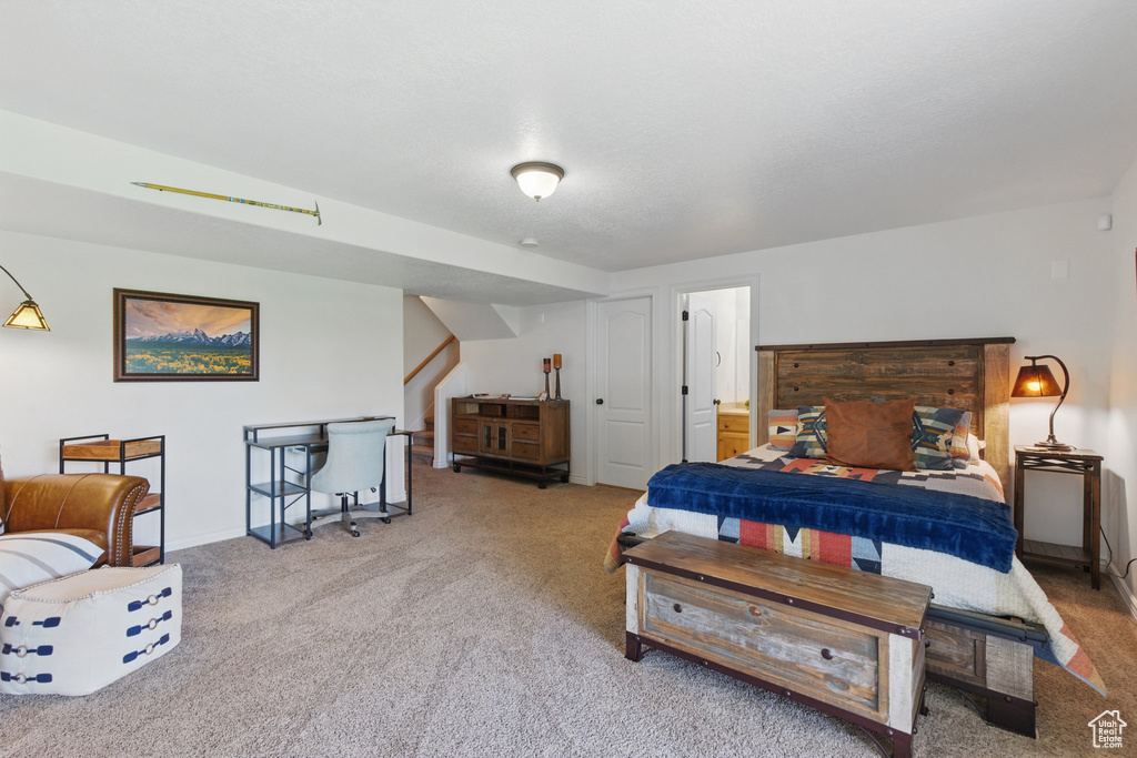Carpeted bedroom featuring baseboards