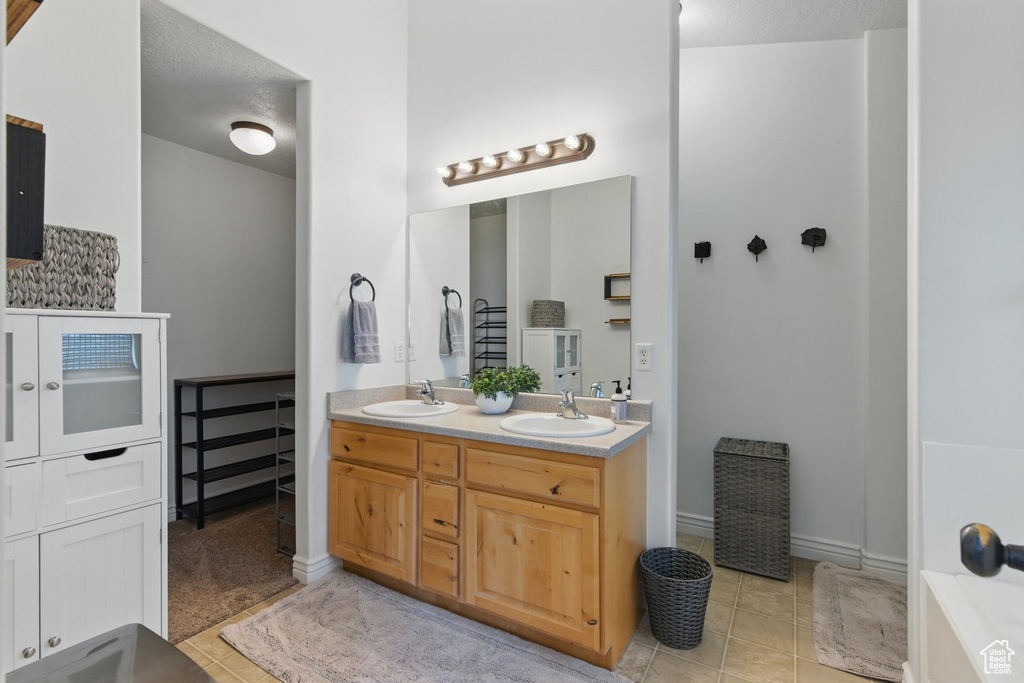Bathroom with tile patterned flooring and double vanity