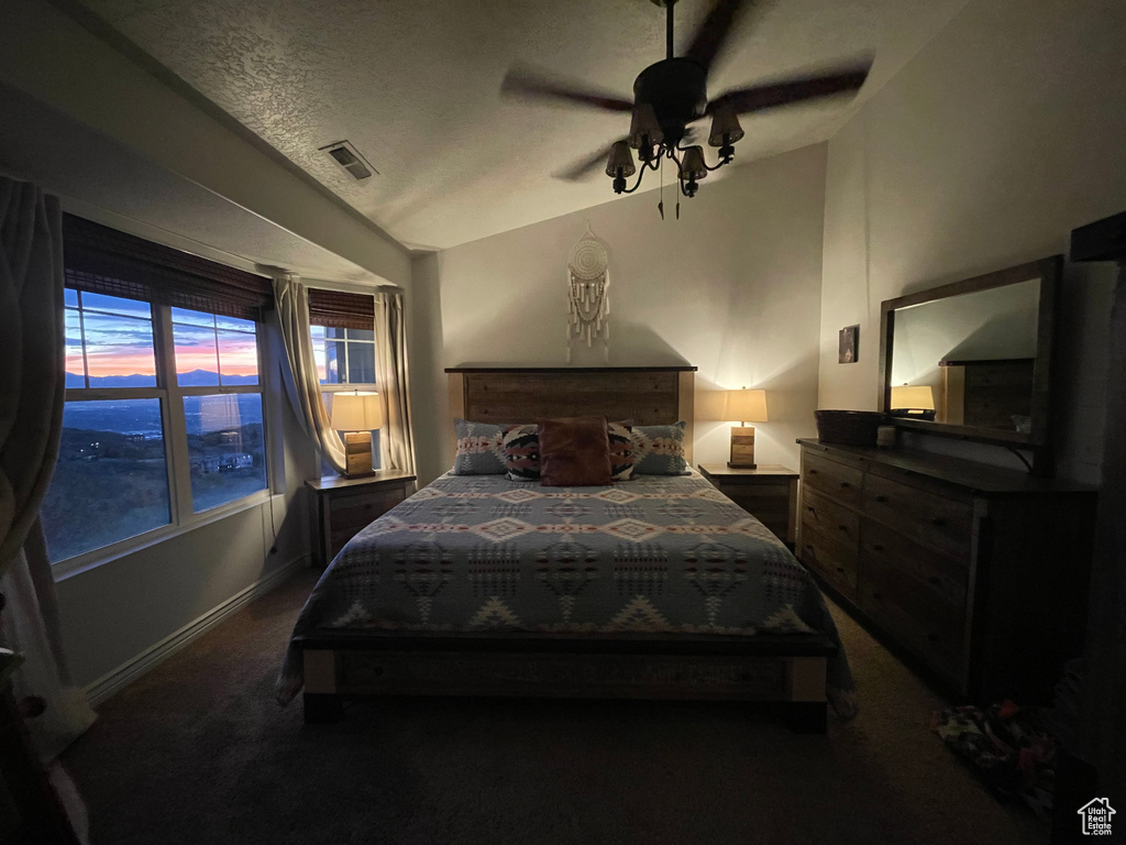 Bedroom featuring dark colored carpet, ceiling fan, and baseboards