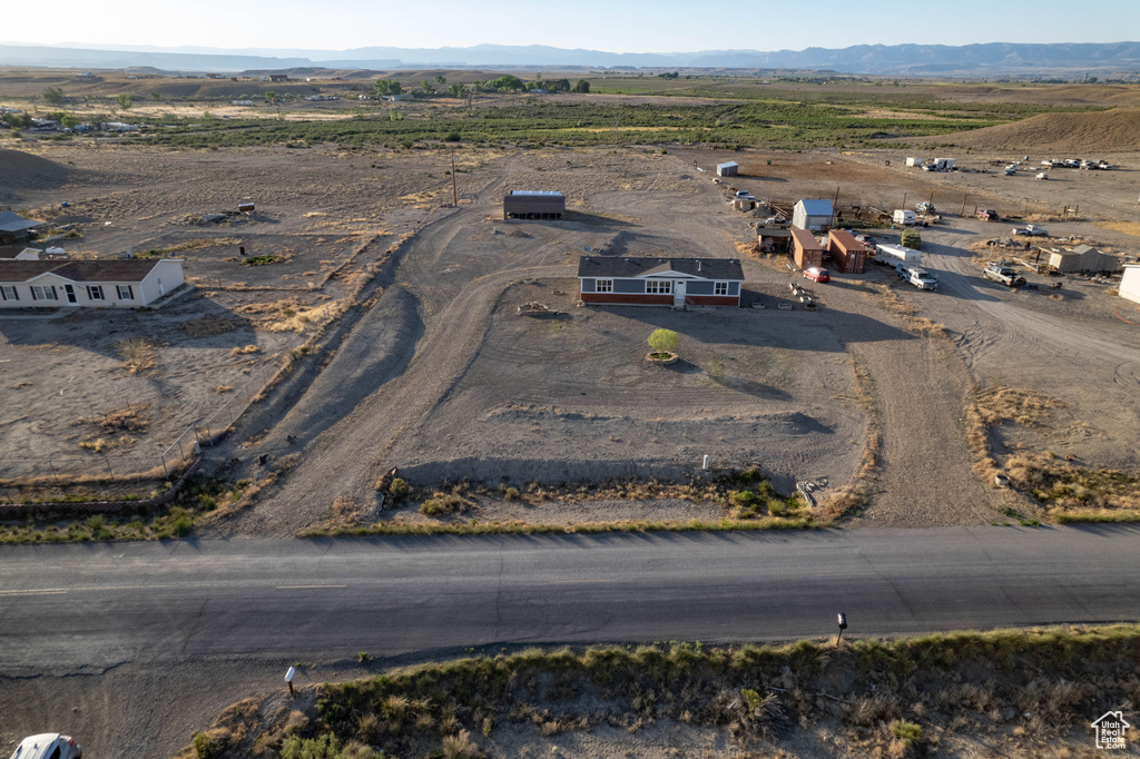 Aerial overview of property's location with rural landscape and a mountainous background