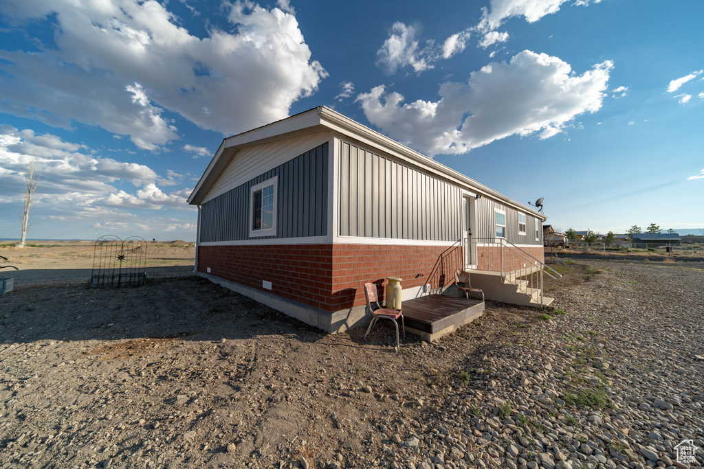 View of side of property with brick siding and board and batten siding