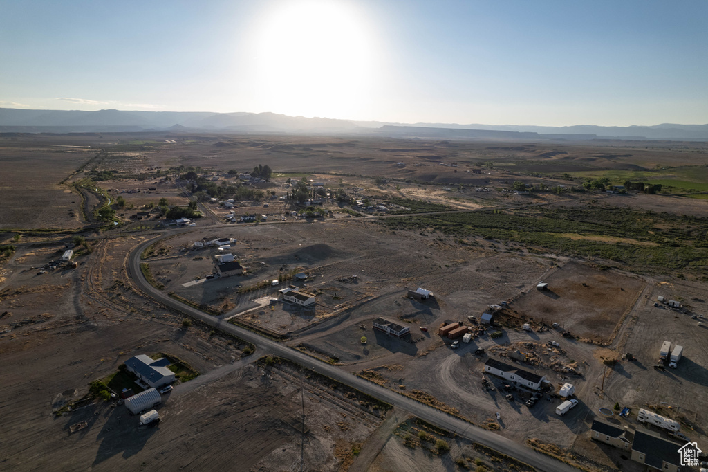 Aerial overview of property's location with a mountainous background and rural landscape