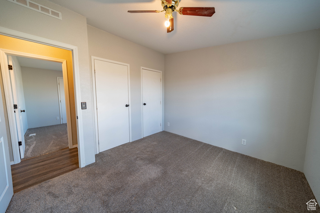 Unfurnished bedroom featuring carpet flooring and ceiling fan