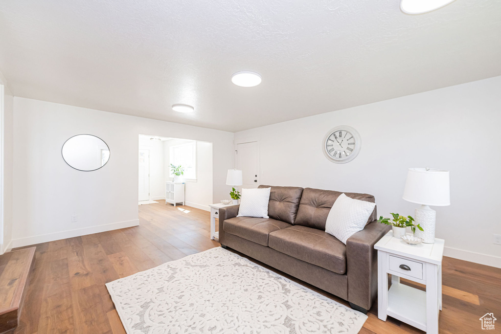 Living area with baseboards and light wood-style flooring