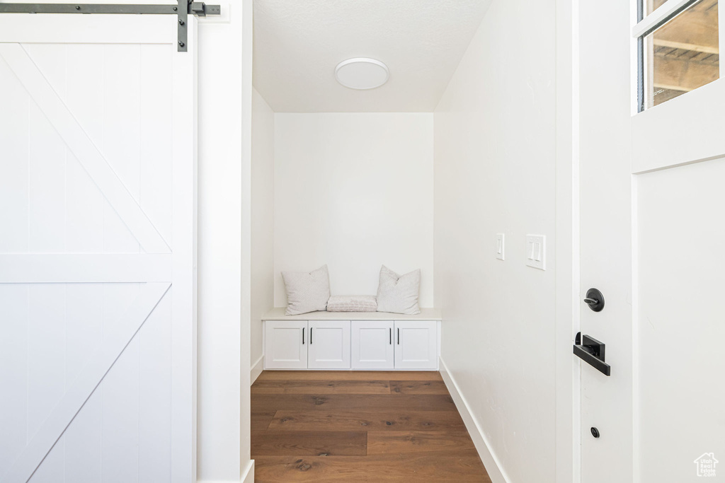 Mudroom featuring baseboards and dark wood-style flooring
