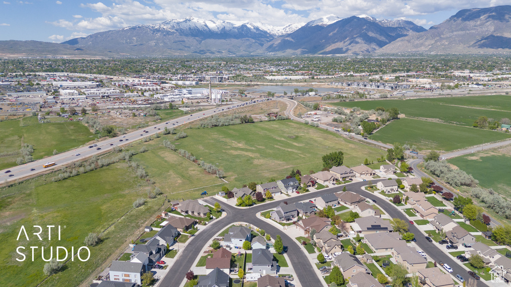 Aerial view of property's location featuring mountains and nearby suburban area