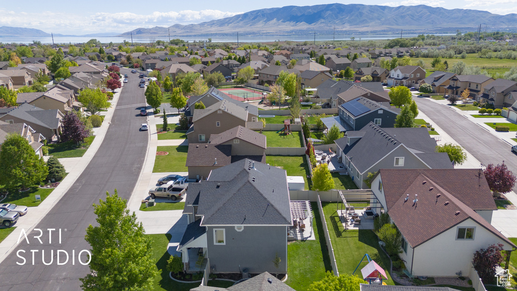 Aerial view of residential area featuring a mountainous background