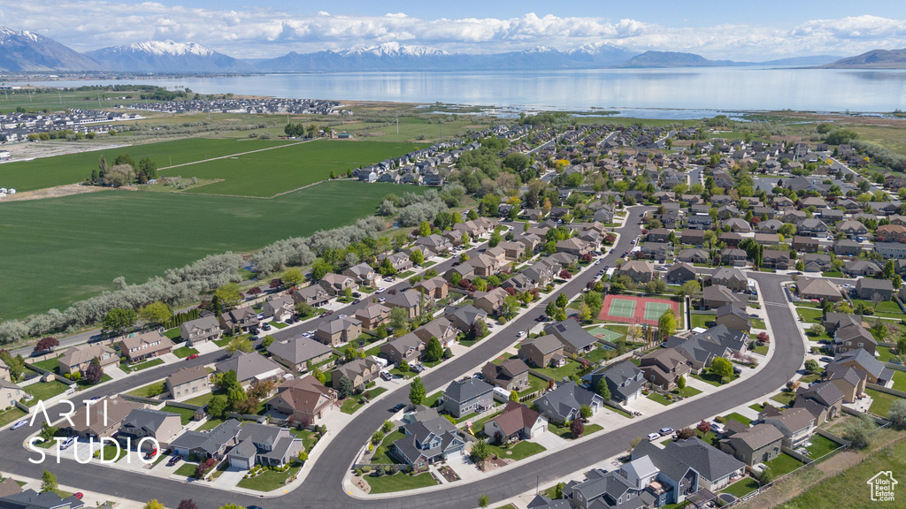 Aerial view of property and surrounding area featuring a water and mountain view