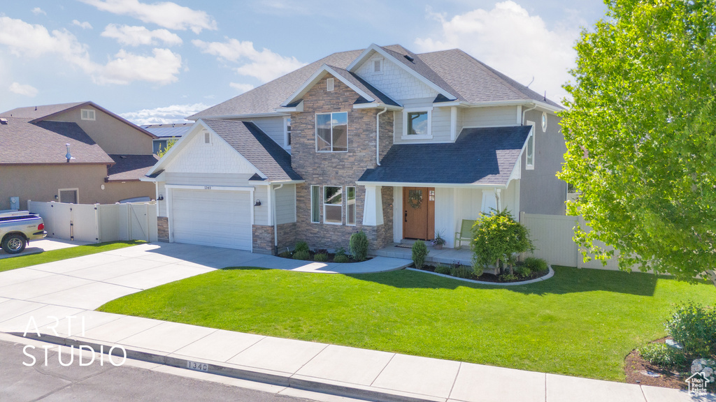 Craftsman inspired home with stone siding, concrete driveway, an attached garage, and a shingled roof