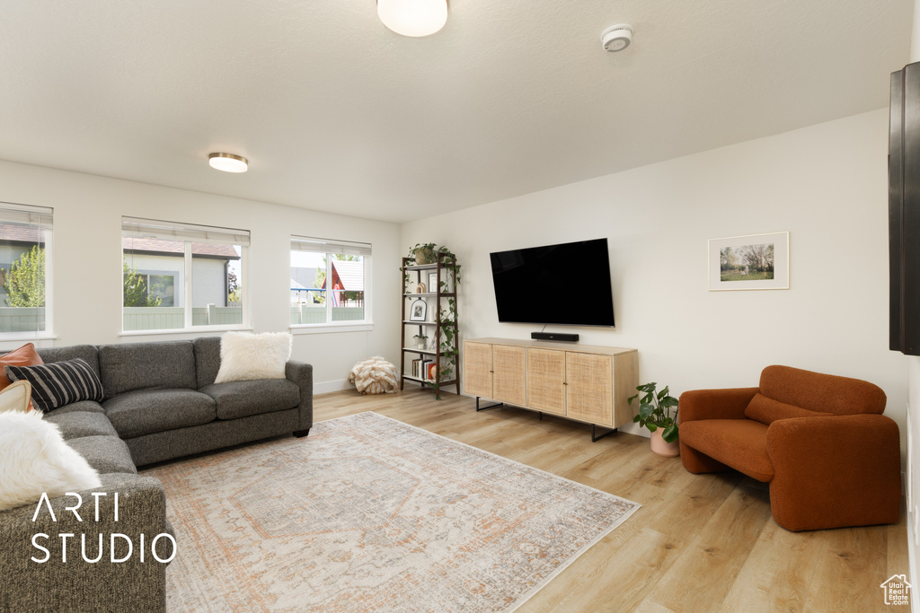 Living area with wood finished floors and baseboards