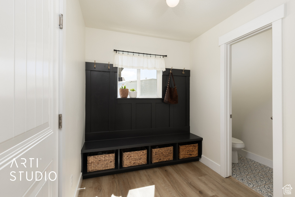 Mudroom with baseboards and wood finished floors