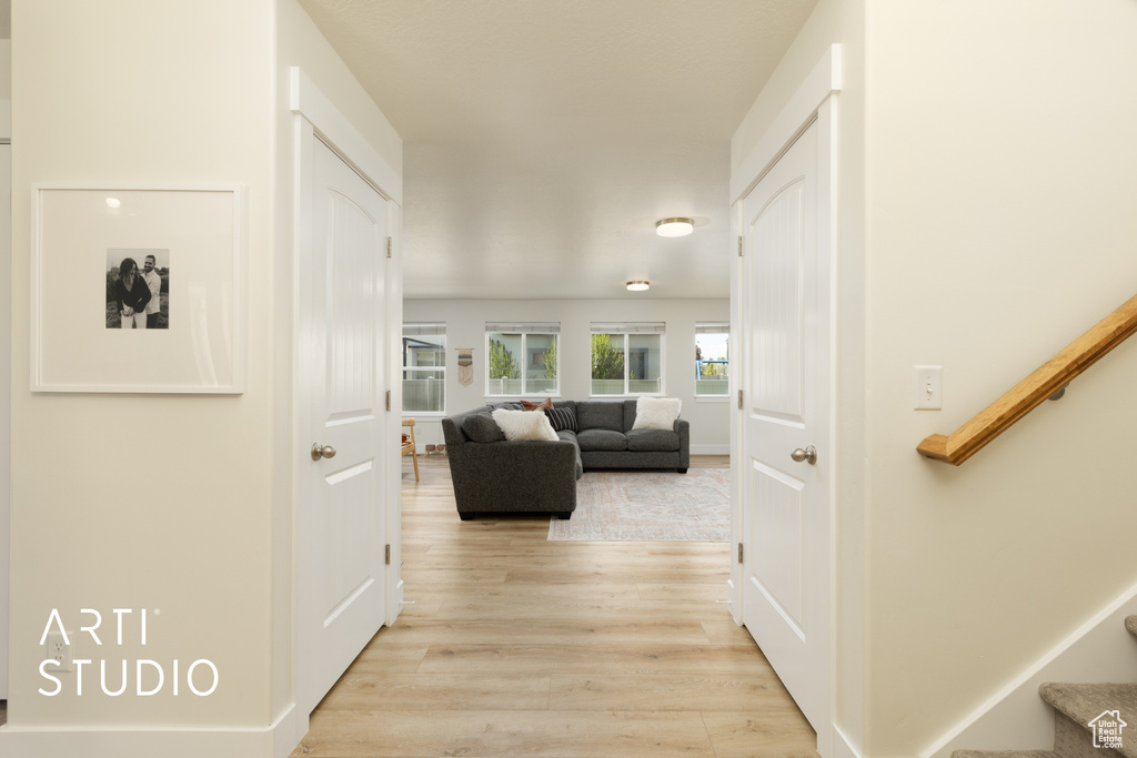 Hall with stairway and light wood-type flooring