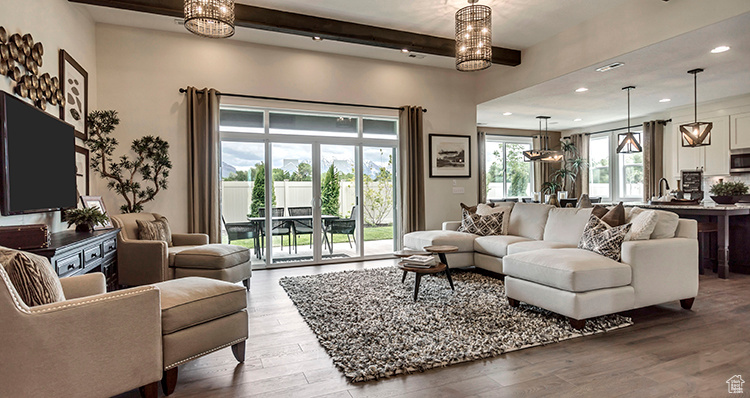 Living area with a chandelier, beamed ceiling, wood finished floors, and recessed lighting