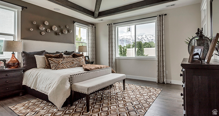 Bedroom with wood finished floors and baseboards