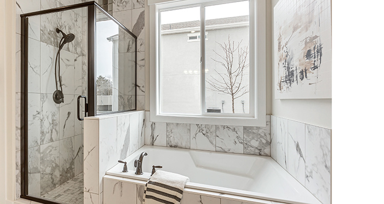 Full bathroom featuring a shower stall and a bath