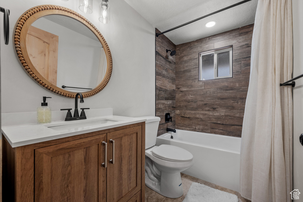 Full bath featuring shower / bath combo, toilet, vanity, and recessed lighting