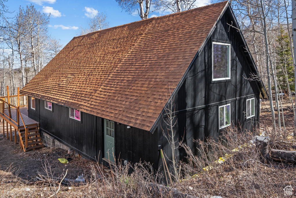 View of home's exterior featuring roof with shingles