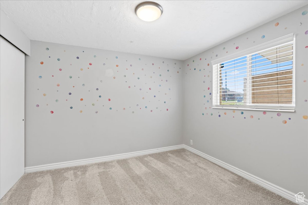 Unfurnished room featuring carpet flooring and baseboards