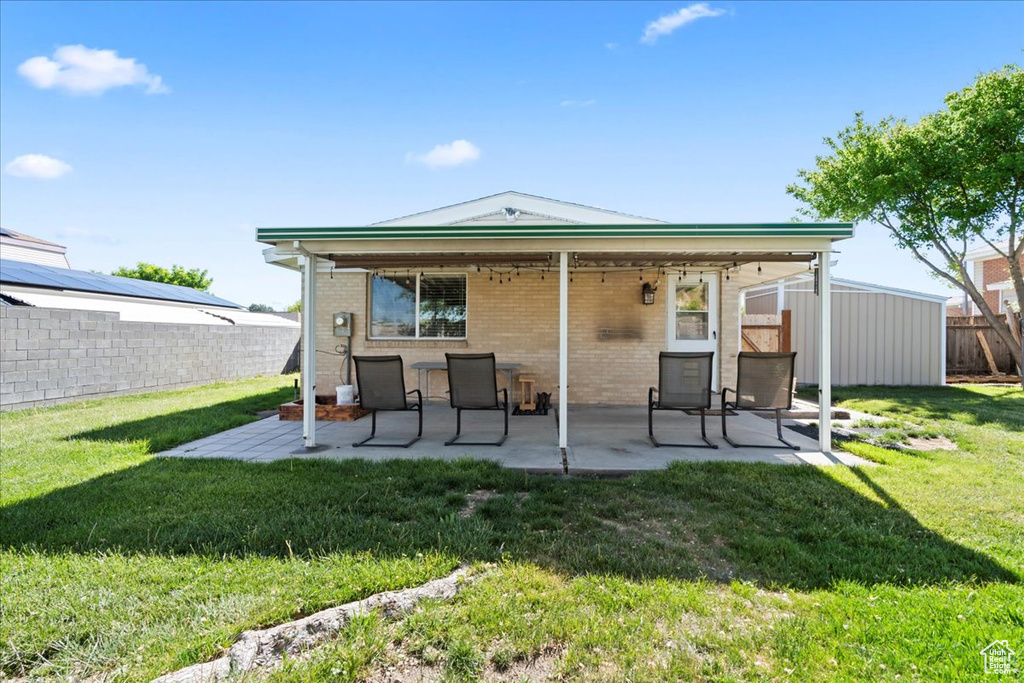 Back of house featuring a patio area and brick siding