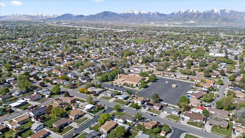 Aerial view of property's location featuring a mountainous background