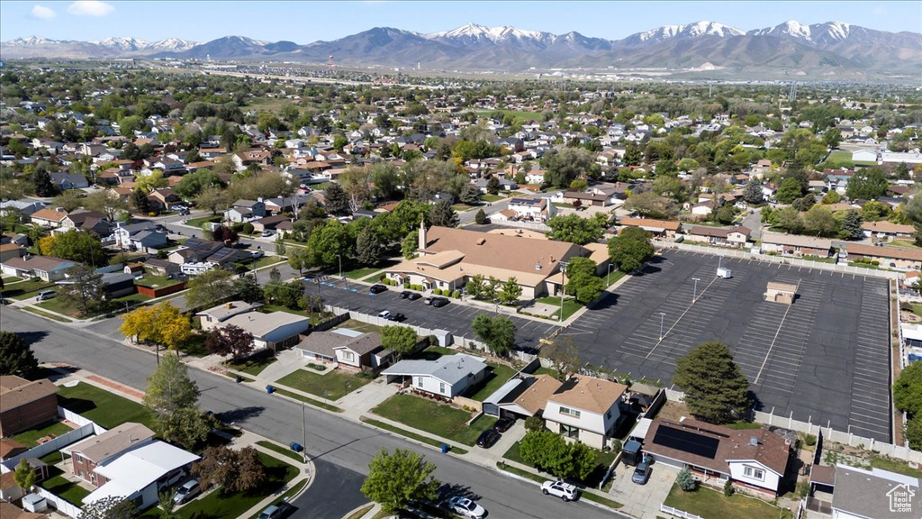 Aerial view of property's location featuring a mountain backdrop and nearby suburban area