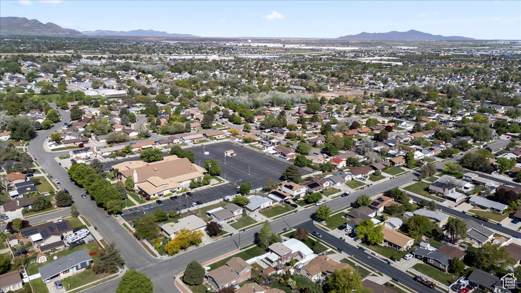 Aerial view of property's location with mountains and nearby suburban area