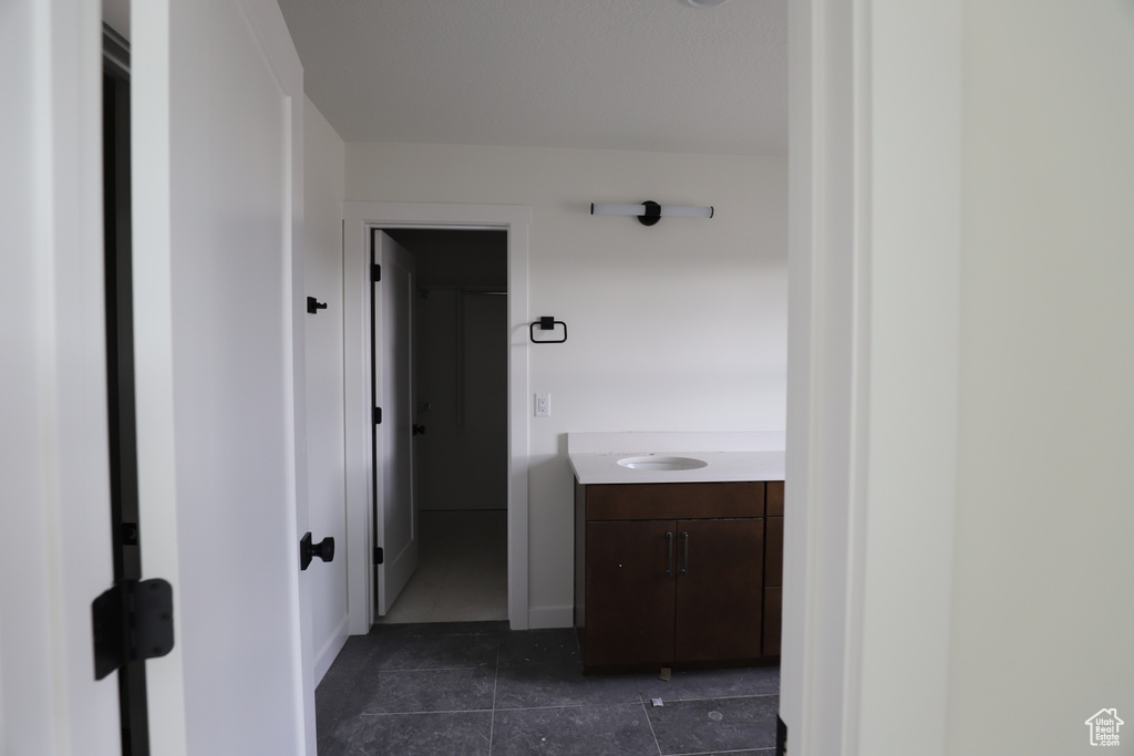 Hall with dark tile patterned flooring