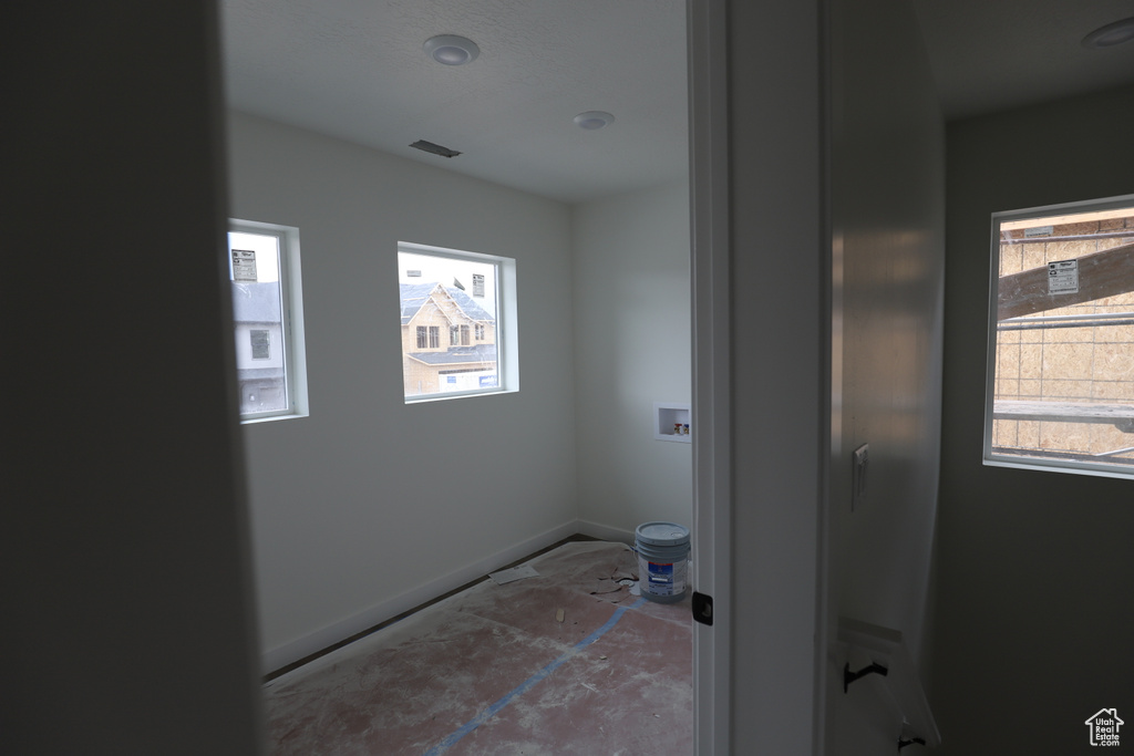 Bathroom featuring plenty of natural light and baseboards