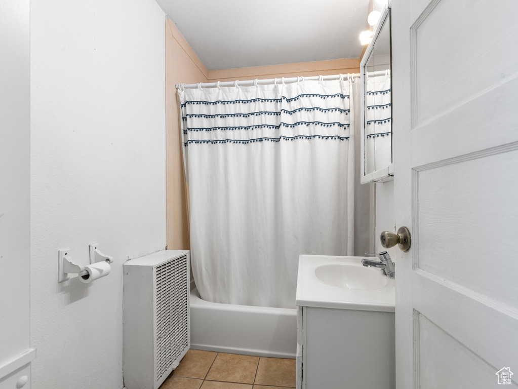 Full bathroom with tile patterned floors, vanity, and shower / bath combination with curtain