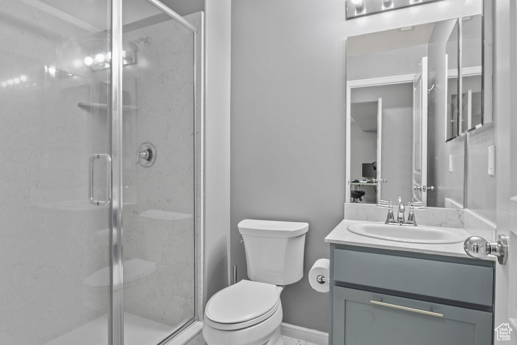 Full bath with a shower stall, toilet, and vanity