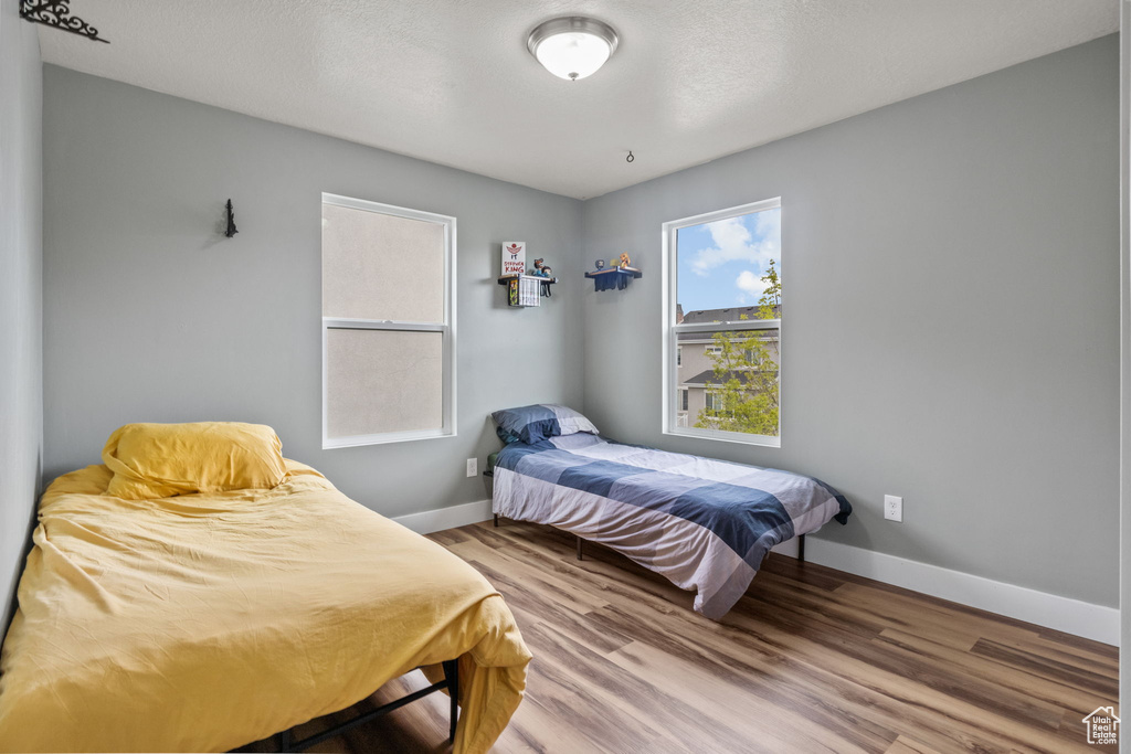 Bedroom with baseboards and wood finished floors
