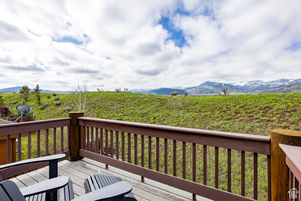 Wooden terrace featuring a mountain view